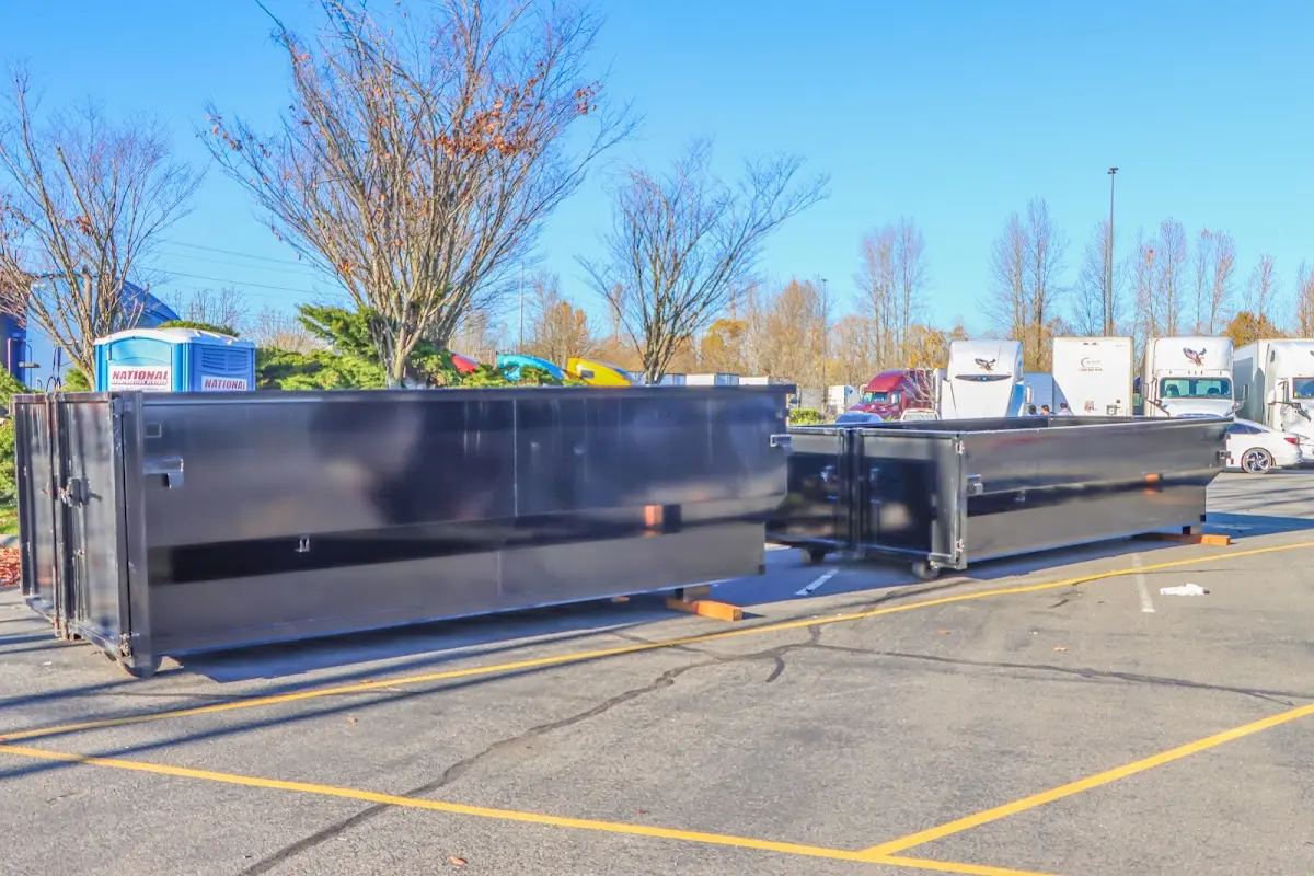 Professional dumpster rental service with roll-off container on residential driveway in Beacon Square